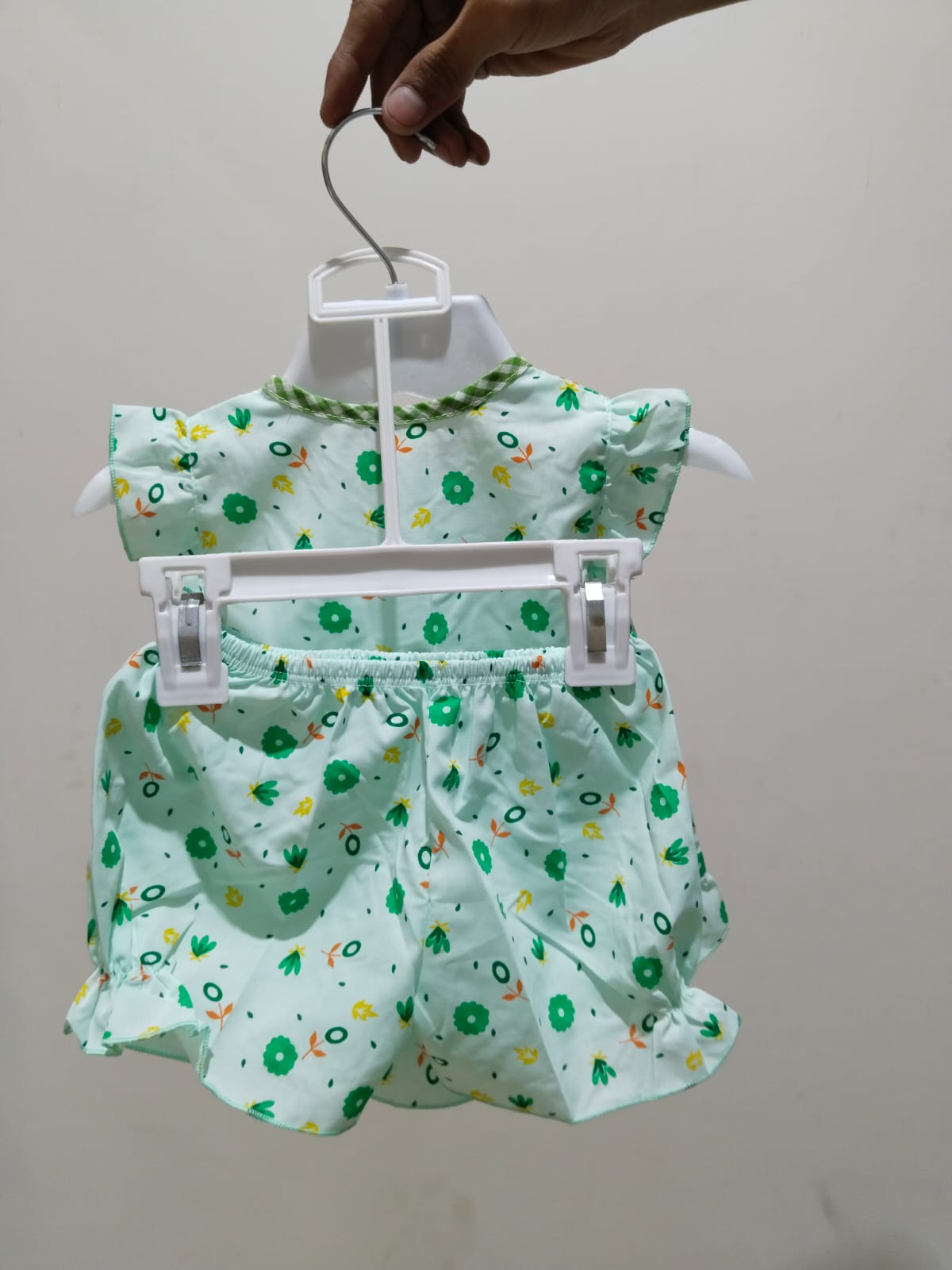 WhatsApp Image 2025-08-09 at 4.48.39 AM Baby Girls Green Floral Summer Top – Sleeveless Cotton Shirt with Ruffle Hem